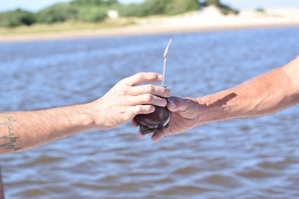 Seguro Viagem Uruguai, pessoa entregando mate